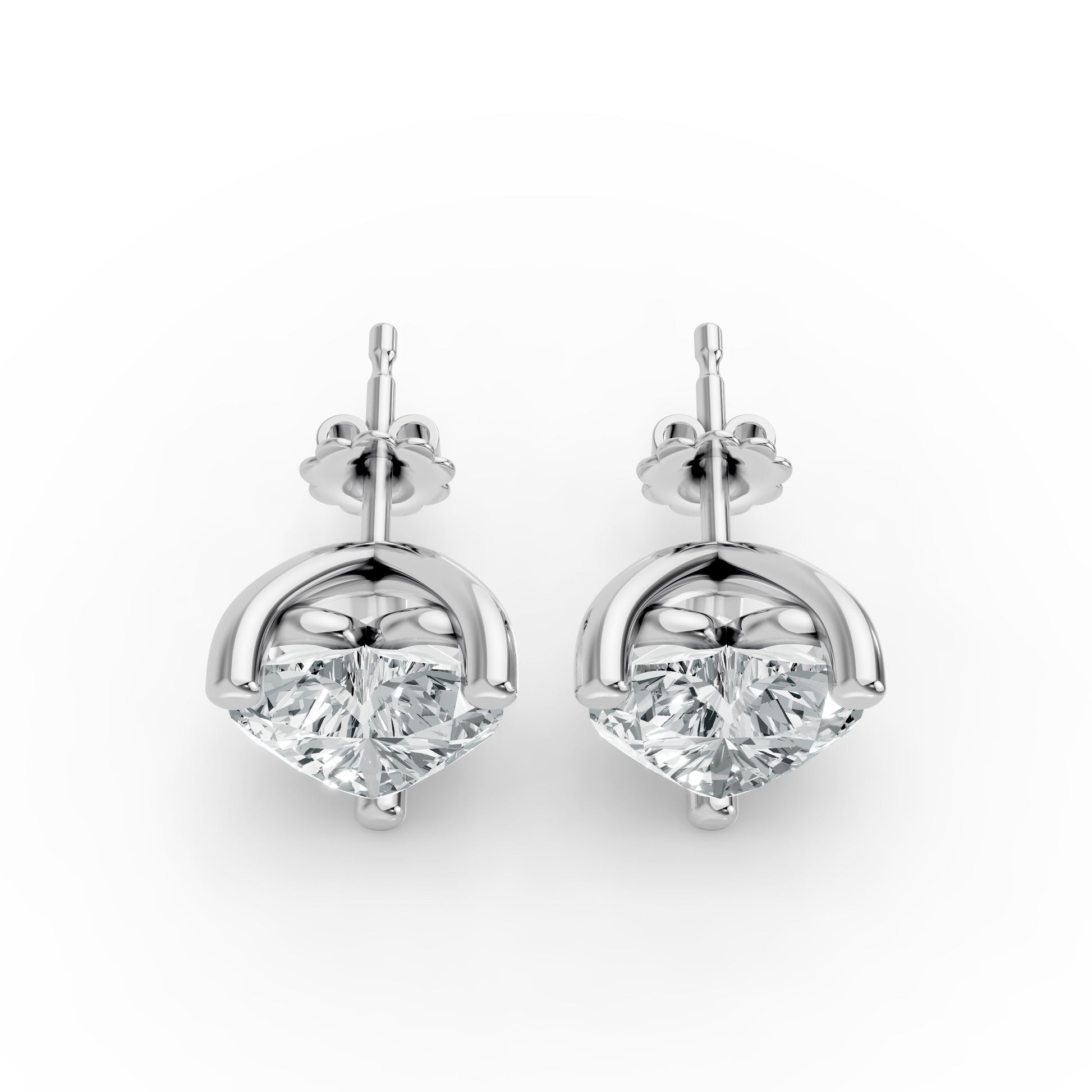 Two sparkling diamond stud earrings set in sleek silver mounts, presented side by side. Elegant and luxurious design.