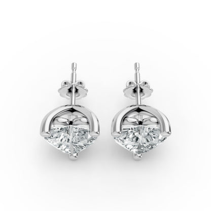 Two sparkling diamond stud earrings set in sleek silver mounts, presented side by side. Elegant and luxurious design.
