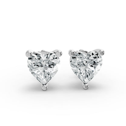 Silver heart-shaped stud earrings with brilliant cut diamonds. They sparkle beautifully, exuding elegance against a white background.