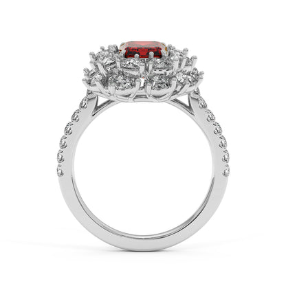 An elegant 14k white gold ring with a 2.50CT red ruby and sparkling round diamonds on the halo and band