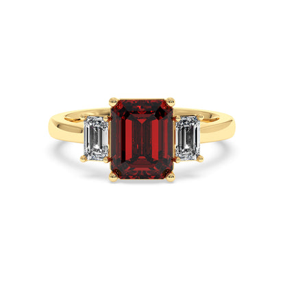 Gold 3.5 carat ruby ring with deep red emerald-cut center stone and two smaller clear emerald-cut stones. Elegant design.