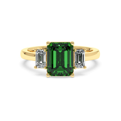 Gold 3.5 carat green YAG ring with large rectangular center gemstone and two smaller rectangular clear stones. Elegant design.