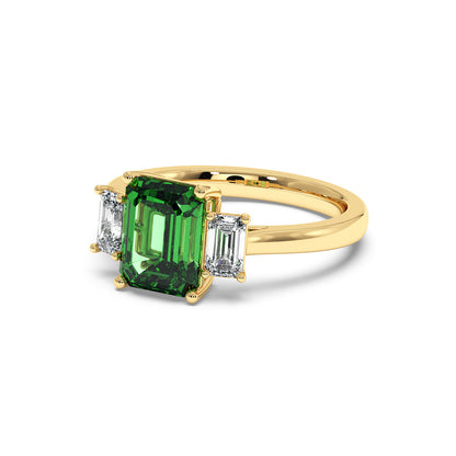 Gold 3.5 carat green YAG ring with emerald-cut center gemstone and two rectangular white diamonds. Elegant, luxurious design.