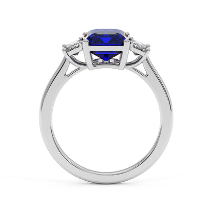 14k white gold 3.5 carat blue sapphire ring with large center gemstone and two smaller clear stones. Elegant design.