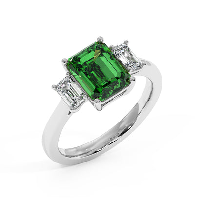 Top view of 14k white gold 3.5 carat green YAG ring with emerald-cut center gemstone and two smaller rectangular diamonds.