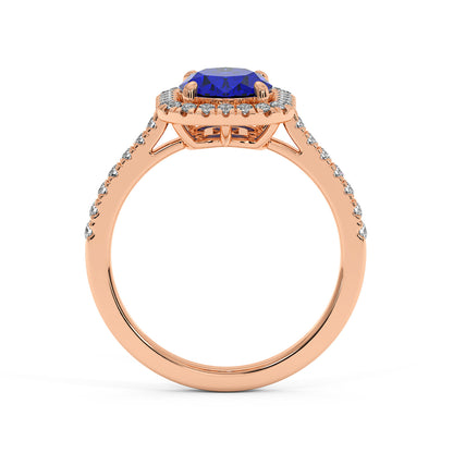 Rose gold engagement ring with a 2.50CT blue sapphire centerpiece, surrounded by diamonds and a diamond-adorned band, exuding luxury and elegance.