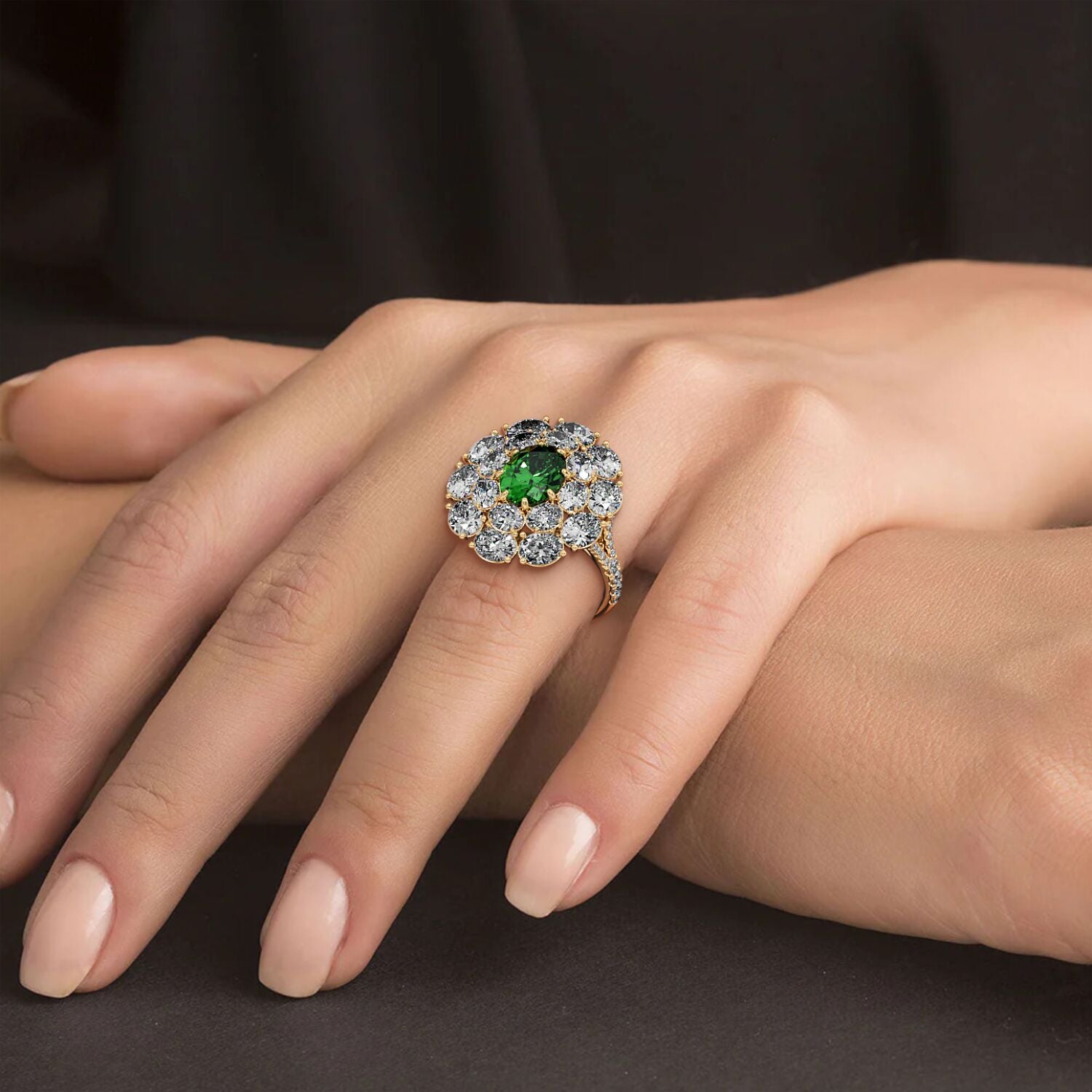 A hand wears a 14k gold ring featuring a 2.50CT oval green YAG surrounded by sparkling diamonds, exuding elegance against a dark background.