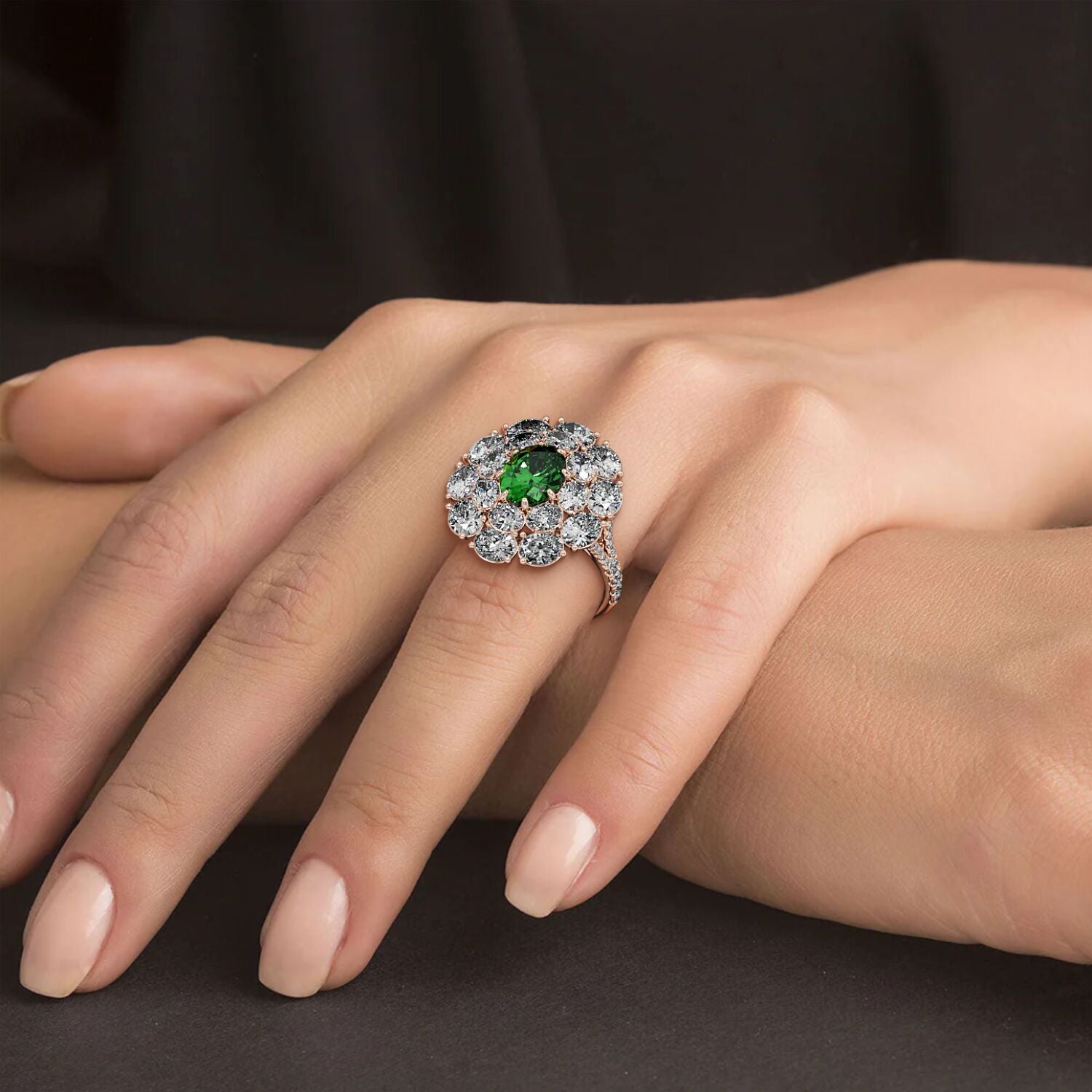 A hand showcases a 14k rose gold ring with a 2.50CT oval green YAG surrounded by sparkling diamonds, exuding elegance and luxury.