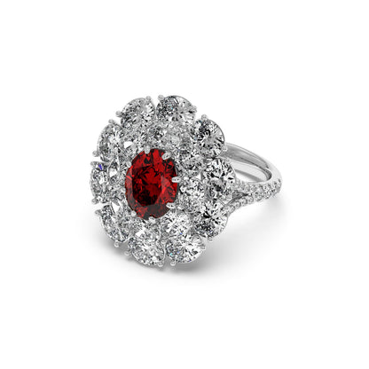14k white gold ring with a 2.50CT oval red ruby surrounded by round diamonds on a sleek, diamond-studded band, exuding elegance and luxury.