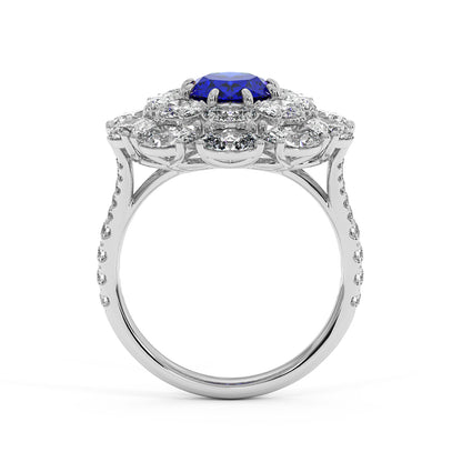 14k white gold ring with a 2.50CT oval blue sapphire surrounded by sparkling diamonds in a floral design, with diamond accents on the band for added elegance.
