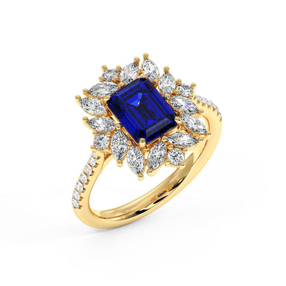 Top view of 14k gold ring with a 2.25CT blue sapphire emerald-cut center, surrounded by marquise diamonds, exuding luxury and sophistication.