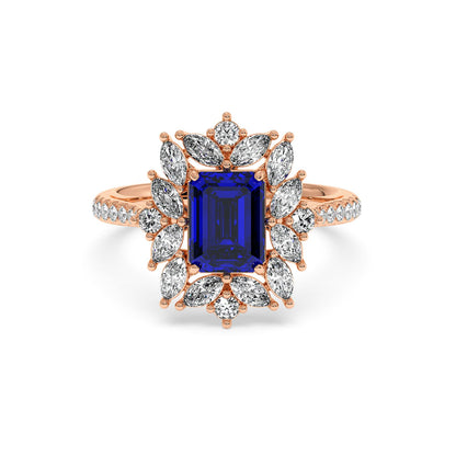 14k rose gold ring with a 2.25CT blue sapphire center surrounded by marquise diamonds in a floral halo design, exuding elegance.