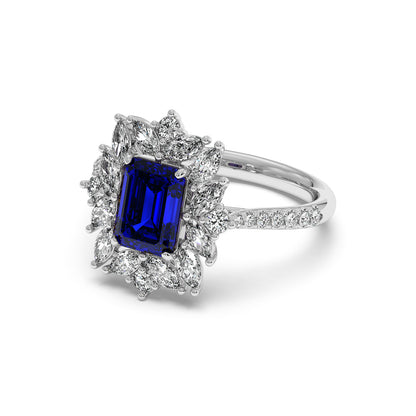 Elegant 14k white gold ring with a rectangular 2.25CT blue sapphire surrounded by sparkling diamonds in a floral pattern.