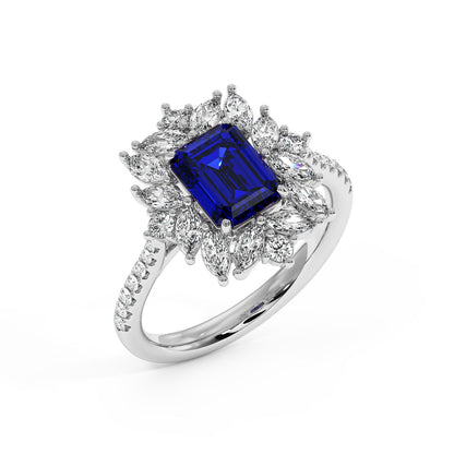 Top view of elegant ring with a rectangular 2.25CT blue sapphire center in a diamond-studded band.