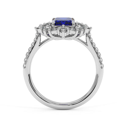 14k white gold ring with a 2.25CT blue sapphire center surrounded by smaller diamonds and a diamond-studded band, exuding elegance.