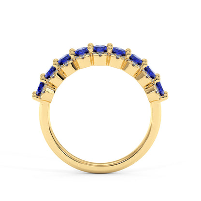 14k gold ring with a row of deep blue sapphires set along the top, contrasting elegantly against the polished gold.