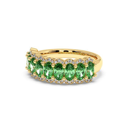 14k gold ring featuring a row of Green YAG oval gemstones bordered by small white diamonds.