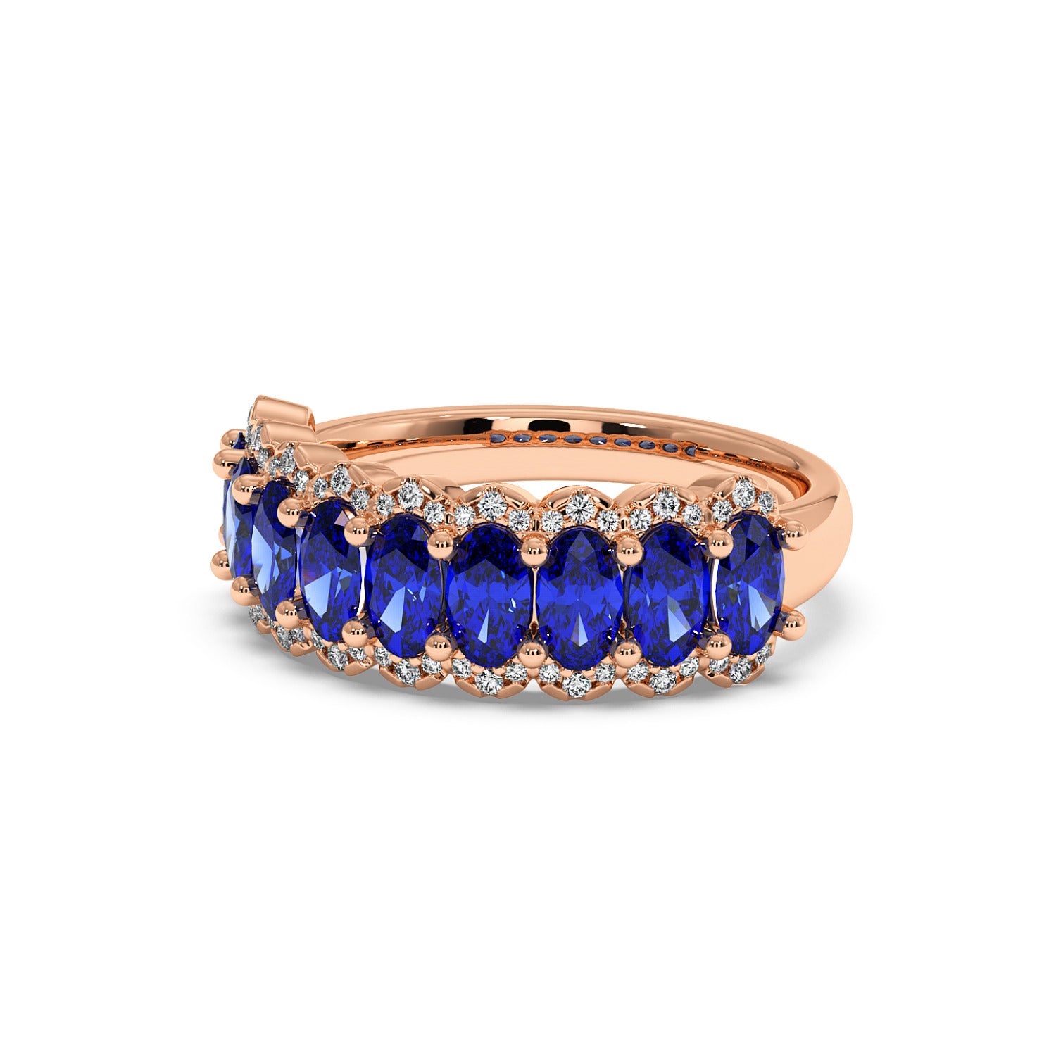 14k rose gold ring adorned with oval Blue Sapphire gemstones, each framed by small sparkling diamonds.