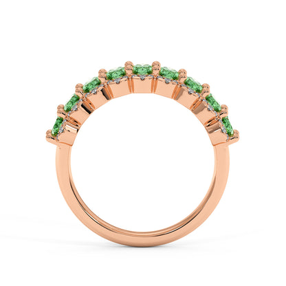 14k rose gold ring with a row of vivid Green YAG stones set into the band, featuring an elegant, modern design, viewed from the side.