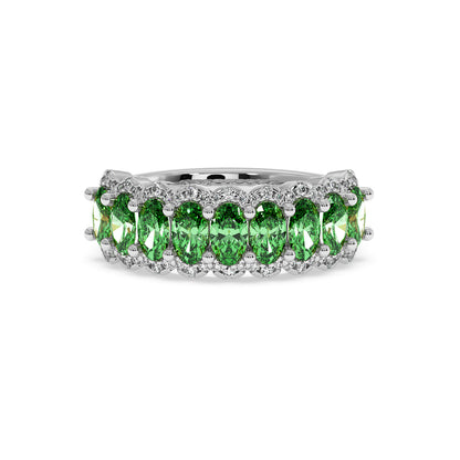 14k white gold ring with vibrant green YAG oval gemstones set in a continuous band, surrounded by small clear stones.