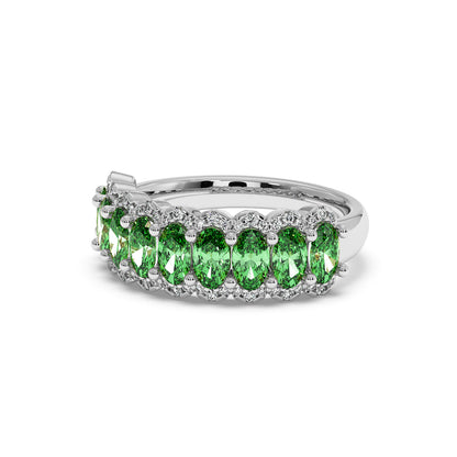 Elegant 14k white gold ring featuring a row of sparkling Green YAG oval stones, each set in intricate prongs.