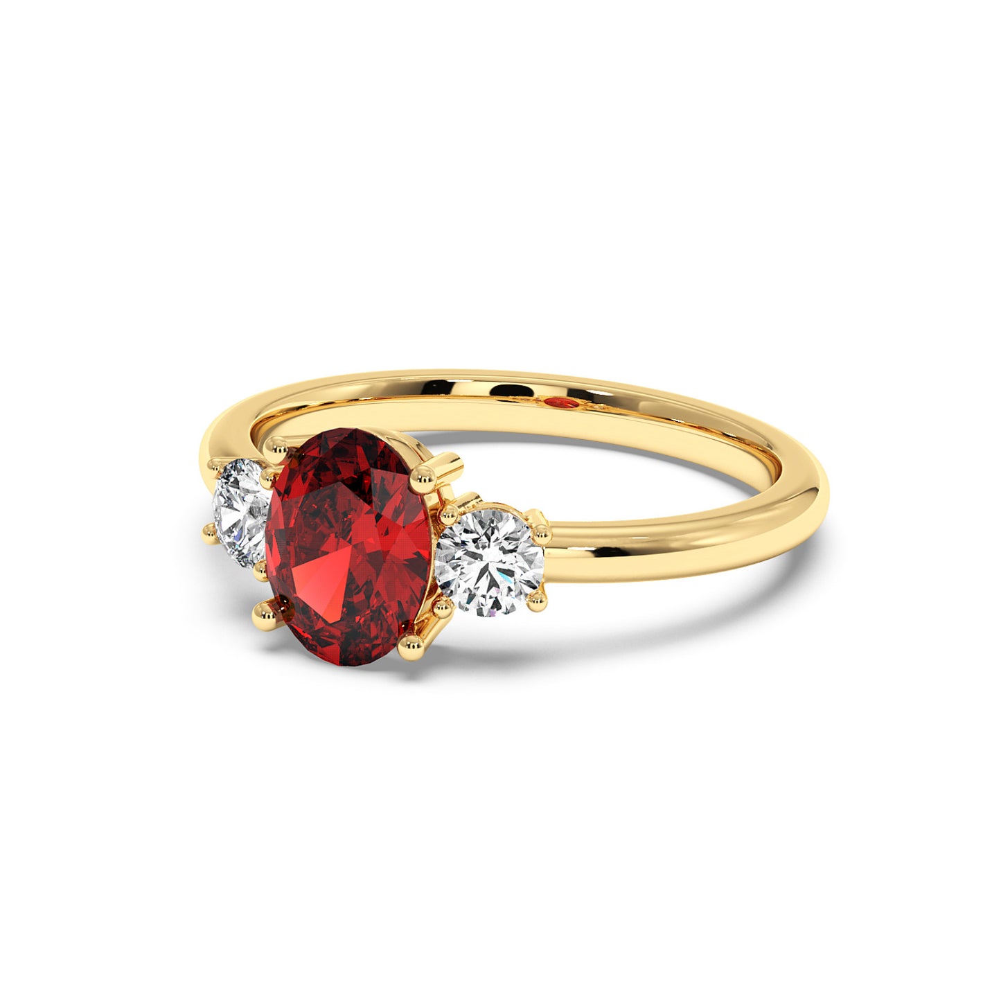 Gold ring with a central red oval ruby flanked by two round diamonds, showcasing an elegant and luxurious design.