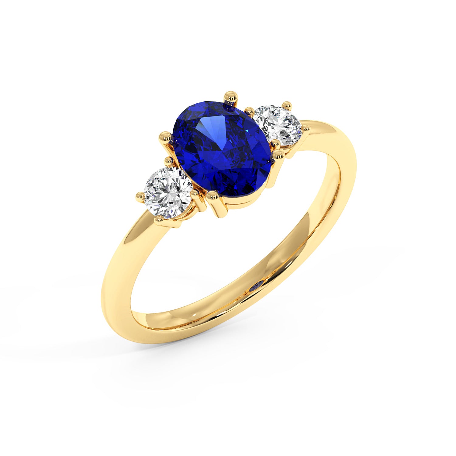 Top view of gold ring with an oval blue sapphire center and two round white diamonds on each side, set against a white background.
