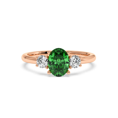Rose gold 1.75CT green YAG ring with oval center gemstone flanked by two round diamonds. Elegant, luxurious design.