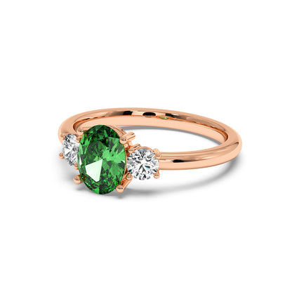 Rose gold 1.75CT green YAG ring with large oval center gemstone and two smaller round diamonds. Elegant, luxurious design, white background.