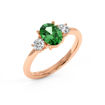 Top view of rose gold 1.75CT green YAG ring with large oval center gemstone and two smaller round diamonds. Elegant design.