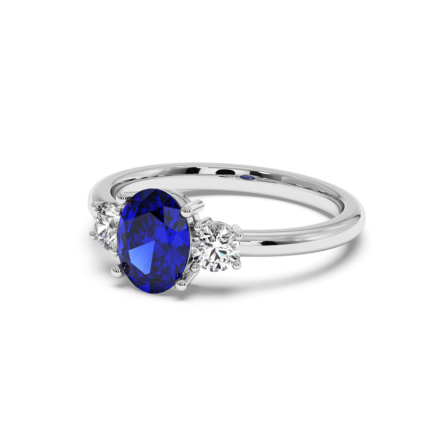 14k white gold ring with an oval blue sapphire center flanked by two round diamonds, exuding elegance and sophistication