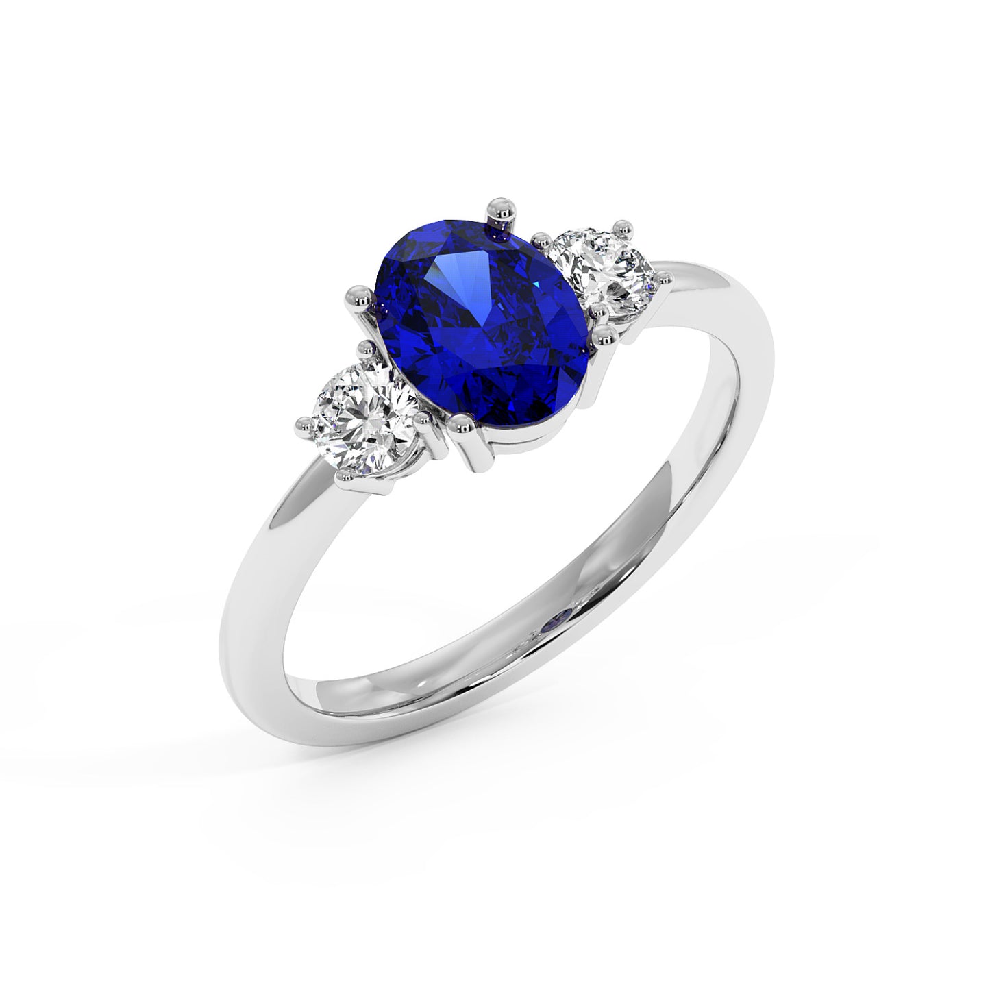 Top view of a 14k white gold ring featuring an oval blue sapphire center flanked by two round diamonds, exuding elegance.