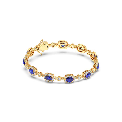 14k gold bracelet featuring oval blue sapphires surrounded by small diamonds, complete with an elegant clasp.