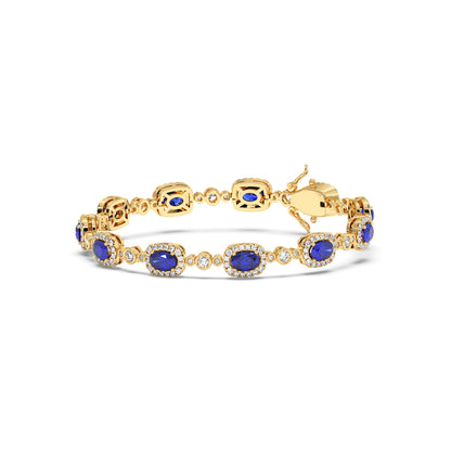14k gold bracelet adorned with oval blue sapphire gemstones and accentuated by small, sparkling diamonds.
