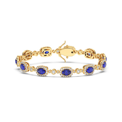 14k gold bracelet with oval blue sapphire stones surrounded by small diamonds in an intricate design.