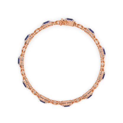 14k rose gold bracelet with intricate links, adorned with blue sapphire and white gemstones in a circular pattern.