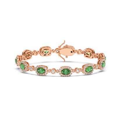 14k rose gold bracelet with oval emeralds encircled by tiny diamonds in an elegant, refined pattern.