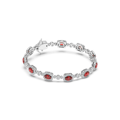 A 14k white gold bracelet adorned with oval ruby gemstones and small circular diamonds in an alternating pattern.