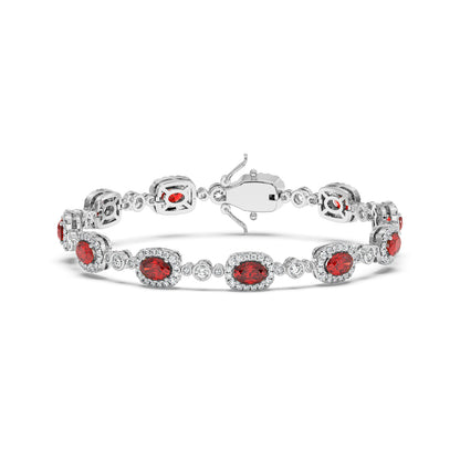 Elegant 14k white gold bracelet with oval ruby gemstones encircled by small white stones.
