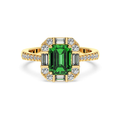 Gold ring with a large emerald-cut green YAG center, surrounded by round and baguette diamonds on a diamond-studded band.