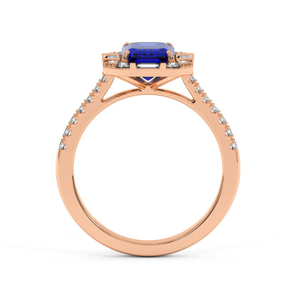 Rose gold emerald ring with rectangular blue sapphire center, surrounded by baguette and round diamonds on band, creating an elegant look.