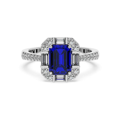 A 14k white gold ring with a large rectangular blue sapphire center surrounded by sparkling white diamonds, band encrusted with more diamonds.