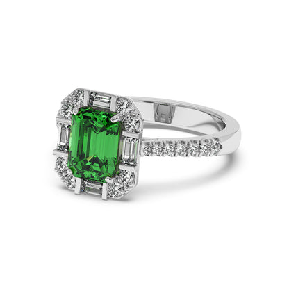 14k white gold ring with a rectangular green YAG center surrounded by sparkling diamonds in a geometric pattern, exuding elegance.