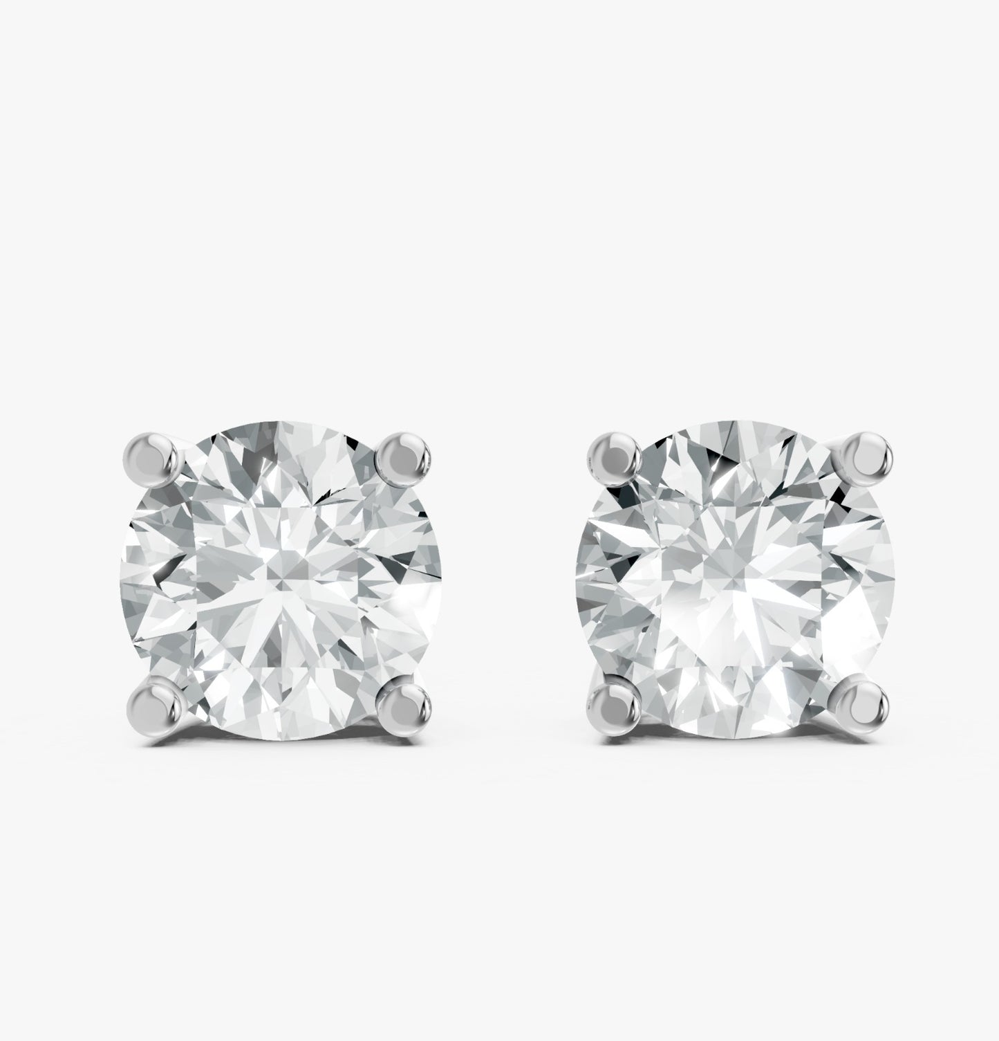 Two sparkling round diamond earrings are set in simple 925 silver prongs against a white background.