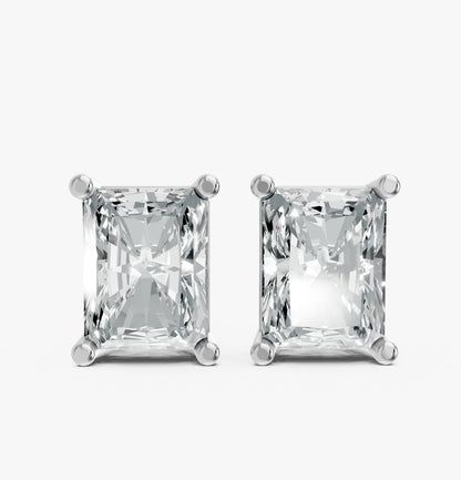 Two radiant-cut lab-grown diamond stud earrings set in four-prong platinum settings. They sparkle, conveying elegance and luxury.
