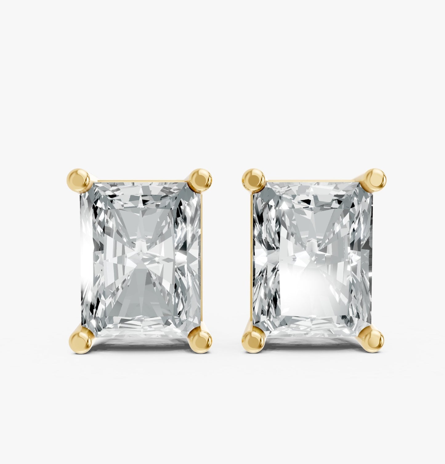Two radiant-cut lab-grown diamond earrings in yellow gold plated settings against a white background. Highlighting brilliance and elegance.