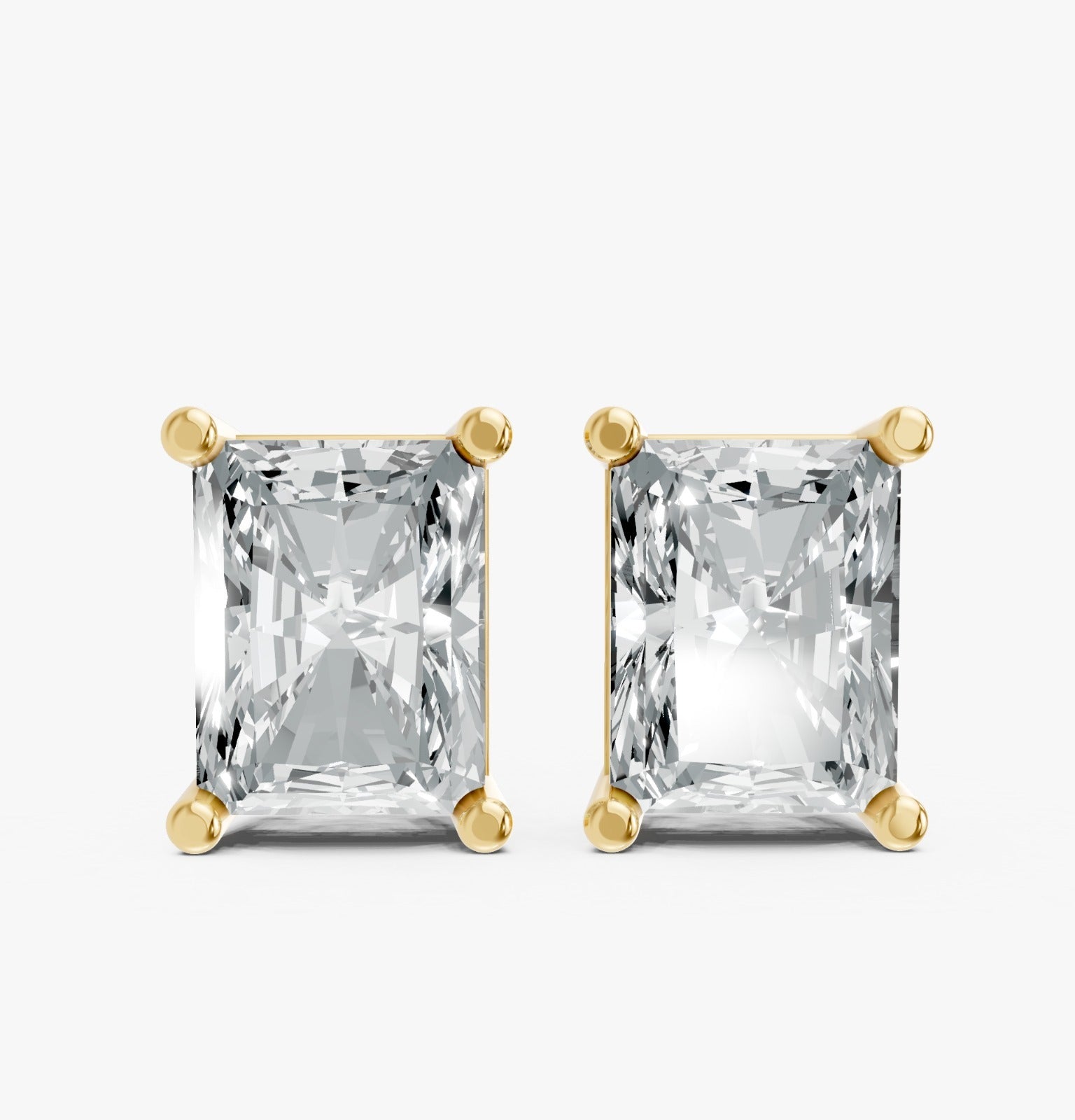 Two radiant-cut lab-grown diamond earrings in yellow gold plated settings against a white background. Highlighting brilliance and elegance.