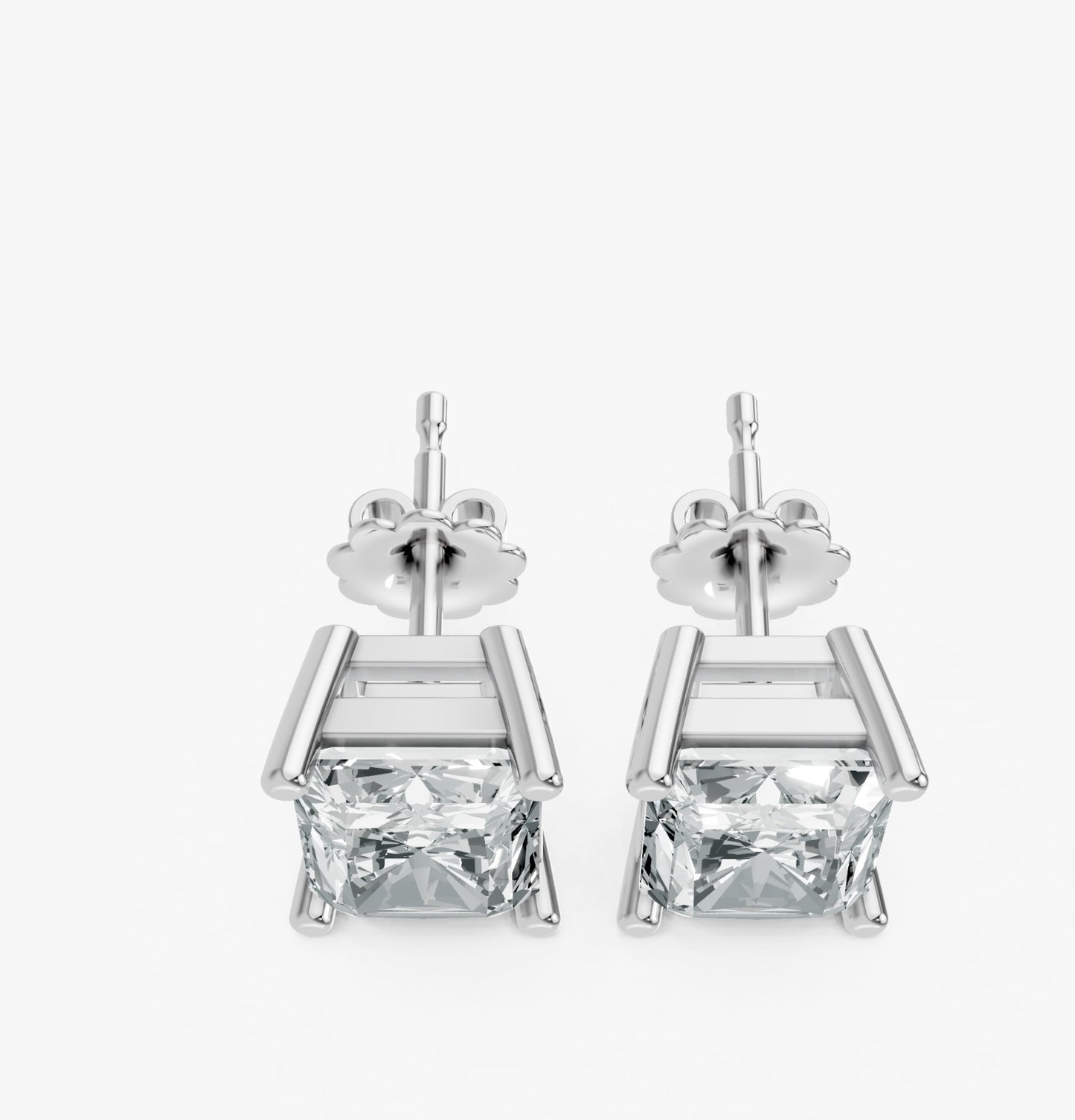 A pair of silver stud earrings feature radiant cut lab-grown gemstones in a sleek prong setting. Exuding elegance and simplicity.