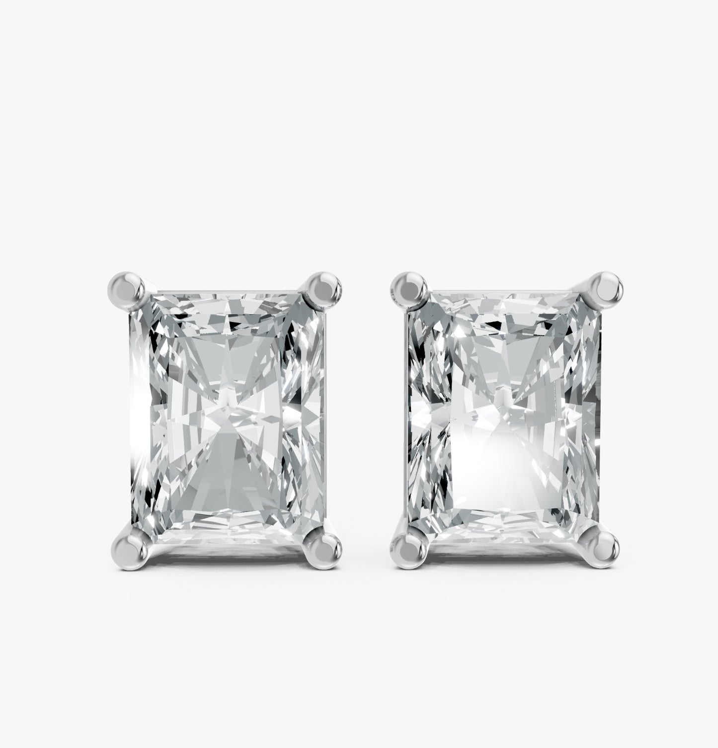 Two radiant-cut lab-grown rectangular diamond earrings in sleek silver prong settings on white. Showcases brilliance and elegance.