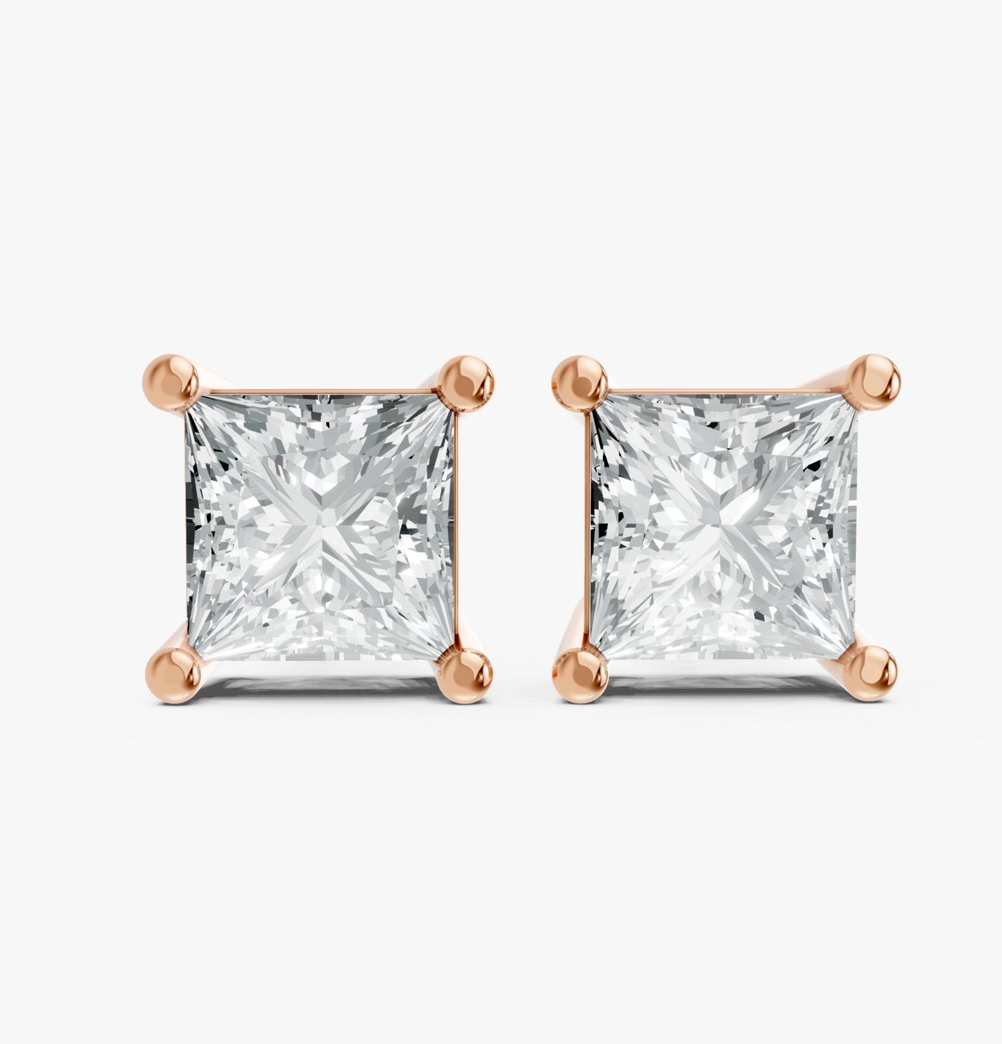 Two princess cut lab-grown diamond stud earrings set in rose gold plated prongs on a white background. Showcasing elegance, luxury, and bright sparkle.
